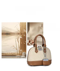Detail of woven shell bag with brown leather trim and mini purse charm for women