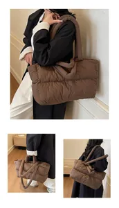 Detail view of coffee-colored quilted down tote bag with soft handles and padded texture