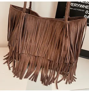 Detailed macro view of bohemian dark brown suede fringe layers on a tote shoulder bag