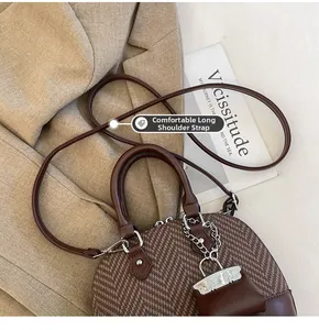 Detail of the comfortable long shoulder strap on vintage brown herringbone crossbody bag