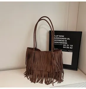 Detail shot of vintage dark brown suede tote bag with dense fringe accents and double straps
