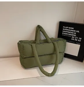 Detailed view of army green quilted tote bag with padded texture and dual straps