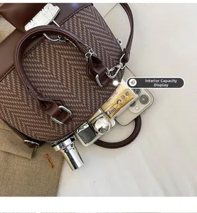 Internal capacity display of vintage brown shell bag showing space for phone and makeup