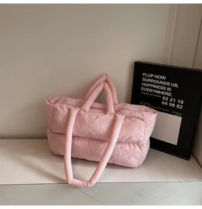 Close-up of pink quilted puffer tote bag with soft texture and dual shoulder straps
