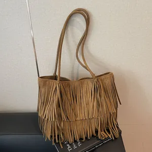 Brown suede tote bag with long bohemian tassels and stylish retro shoulder straps