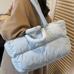 Light blue quilted puff tote bag with double handles for stylish autumn winter commuting