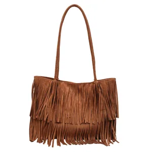 Brown suede tote bag featuring bohemian tassels and vintage minimalist aesthetic
