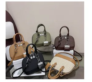 Detailed collection of five shell-shaped crossbody bags featuring woven texture and leather trim