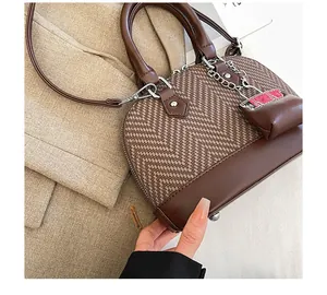 Top view of two-tone shell handbag with chevron woven texture and leather details