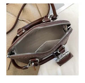 Detailed interior of vintage shell bag showing wave pattern lining and inner pocket