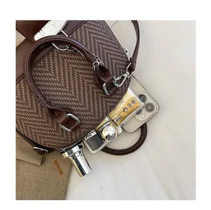 Interior view of brown vintage shell bag showing storage space for phone and makeup
