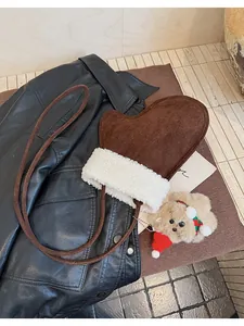 Detailed view of coffee brown plush mittens with sherpa fleece trim and bear charm