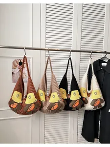 Close-up of colorful knit tote bags with cute cartoon bear patches and V-textured patterns