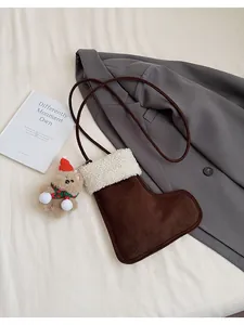Close-up of boot-shaped plush bag with fuzzy trim and a cute teddy bear charm