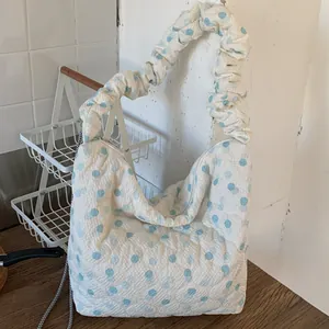 Quilted cloud shoulder bag with light blue polka dots and pleated strap design