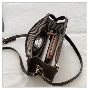 Interior view showing striped lining and storage capacity of the brown crossbody bag