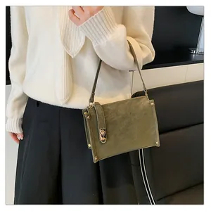 Olive green matte square shoulder bag detail with gold rivets and metallic twist lock