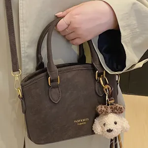 Vintage dark brown crossbody bag with handle and plush charm for daily style