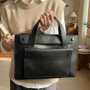Minimalist black waterproof laptop tote bag in premium faux leather for business women