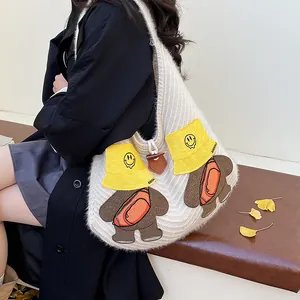 Chic cream knitted tote bag featuring a cute cartoon bear embroidery with yellow sun hat