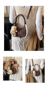 Detail of suede crescent bag featuring plush shearling trim and brown leather bow