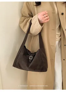 Retro dark brown matte leather shoulder bag styled with a beige trench coat
