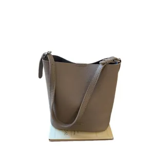 Taupe lychee grain leather bucket bag with top handle and shoulder strap for daily commuting