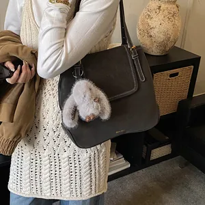 Retro charcoal grey suede bucket tote bag with white stitching and rabbit charm