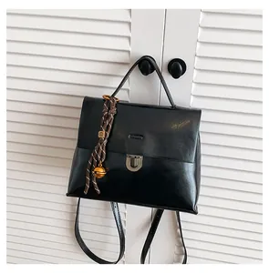 Details des schwarzen Rucksacks aus Kunstleder mit silberner Schnalle und Goldglocke