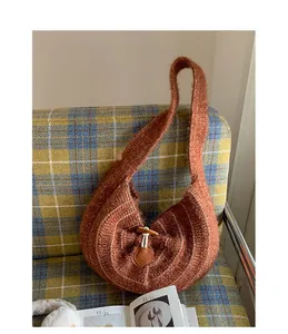 Macro detail of brown knit mohair hobo bag featuring a vintage toggle button closure