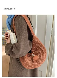 Detail of knit shoulder bag with brown leather clasp and woven concentric texture