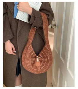 Detail of caramel knit hobo bag featuring ribbed texture and stylish horn button closure