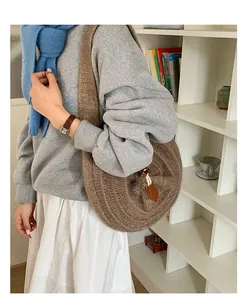Detail of coffee brown circular knit shoulder bag with intricate 3D spiral crochet texture
