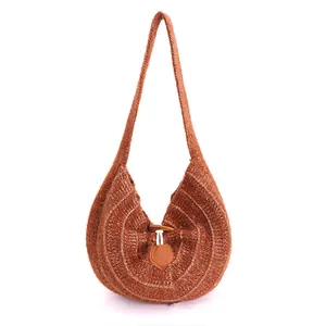 Brown knit shoulder bag with horn buckle closure and minimalist U-shaped design