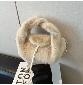 Détail d'un sac à main en peluche avec poignée nouée et bandoulière en cuir réglable
