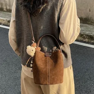 Vintage coffee brown suede bucket bag with adjustable strap and cute plush bear charm