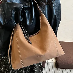 Brown large capacity tote bag with white contrast stitching and wide shoulder strap