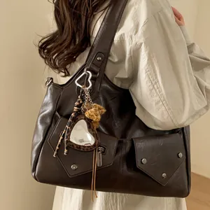 Retro deep brown large tote bag with leopard heart charm worn by model over the shoulder