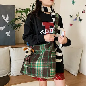 British style plaid wool tote bag with plush puppy pendant shown in lifestyle setting