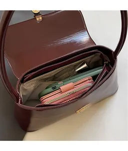 Top view of vintage burgundy leather handbag showing spacious interior and golden hardware