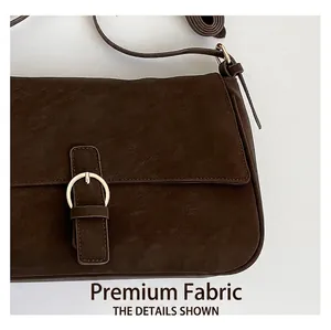 Detail view of brown vintage textured PU leather crossbody bag with golden ring buckle