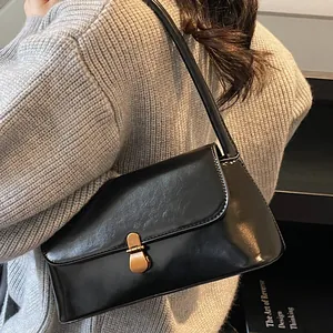 Retro black faux leather underarm bag with gold metal buckle for daily commute styling