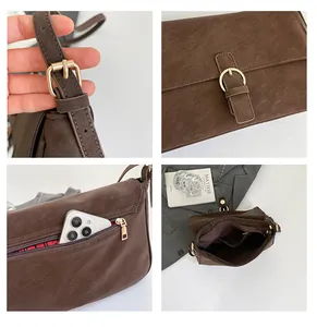 Close-up of brown vintage bag with gold hardware and secure rear zipper phone pocket
