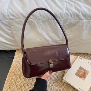 Vintage burgundy glossy patent leather shoulder bag with elegant gold buckle hardware