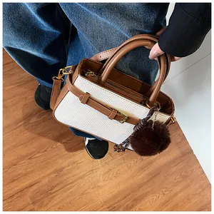 Top view of a retro bucket bag with white textured fabric and brown leather straps