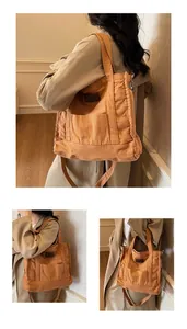 Detail of caramel canvas tote bag with adjustable strap and fashion leather patch