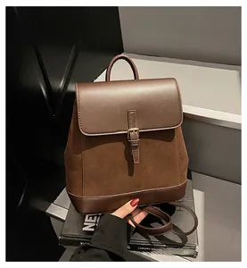 Detail view of the brown faux suede and leather textures on this casual backpack