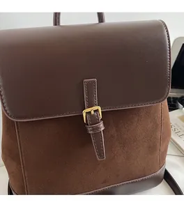 Detail of vintage coffee brown backpack with leather splicing and golden buckle