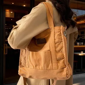 Brown canvas tote bag for women with leather tag and adjustable shoulder strap
