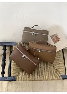 Three minimalist textured leather box bags in brown, caramel, and taupe with silver zippers